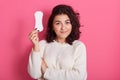 Good looking feminine girl holds clean sanitary napkin, has menstrual cycle, happy to have good women health, female with dark