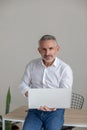 Good-looking gray-haired man working on laptop Royalty Free Stock Photo