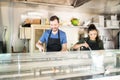 Happy cooks in a food truck