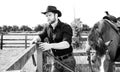 Handsome cowboy, horse rider on saddle, horseback adn boots Royalty Free Stock Photo