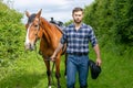 Handsome cowboy, horse rider on saddle, horseback adn boots Royalty Free Stock Photo