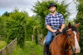 Handsome cowboy, horse rider on saddle, horseback adn boots Royalty Free Stock Photo