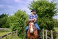 Handsome cowboy, horse rider on saddle, horseback adn boots