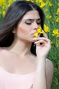 Good looking lady smelling yellow flower