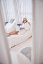 Happy smiling woman enjoying cool weekend while using laptop and internet in spa resort hotel Royalty Free Stock Photo