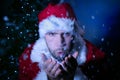 Good looking male Santa blowing snow at lens Royalty Free Stock Photo