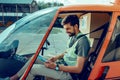 Concentrated short-haired man checking planed rout on his tablet