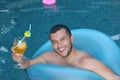 Good looking man drinking cocktail in swimming pool Royalty Free Stock Photo