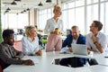 Good-looking pleasant female boss executive discuss business ideas with employees