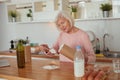 Diligent aged woman cooking at home kitchen