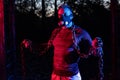 Good looking strong muscular man working out in the park with weightlifting chains while wearing breathing high altitude Royalty Free Stock Photo