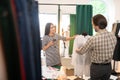 Good-looking talented fashion designer getting measurements of a dress