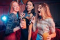 Emotional cheerful women in karaoke bar Royalty Free Stock Photo