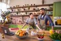 Good looking woman getting excited while she looking over the laptop in the kitchen together with her boyfriend she Royalty Free Stock Photo