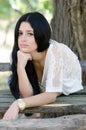 Good looking woman sitting on a wooden table Royalty Free Stock Photo