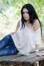 Good looking woman sitting on a wooden table Royalty Free Stock Photo