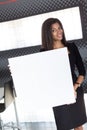 Good looking young business lady in black strong suite hold empty paper Royalty Free Stock Photo