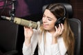 Female singer performing live song at radio station