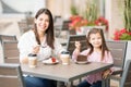 Woman with her little daughter having cake Royalty Free Stock Photo