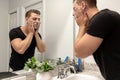 Good Looking Young Man Washing Hands and Face in Home Bathroom Mirror and Sink Getting Clean and Groomed During Morning Routine Royalty Free Stock Photo