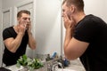 Good Looking Young Man Washing Hands and Face in Home Bathroom Mirror and Sink Getting Clean and Groomed During Morning Routine Royalty Free Stock Photo
