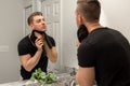 Good Looking Young Man Washing Hands and Face in Home Bathroom Mirror and Sink Getting Clean and Groomed During Morning Routine Royalty Free Stock Photo