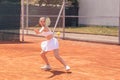 Good looking young woman professional tennis player hitting the ball hard outdoor on the tennis court she wearing Royalty Free Stock Photo