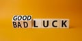 Good Luck and bad Luck symbol. Turned wooden cubes with words Bad Luck and Good Luck. Beautiful orange background. Business Royalty Free Stock Photo