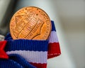 Close-up of Tail back side of penny on red, white and blue ribbon