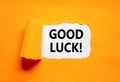 Good luck symbol. Concept words Good luck on beautiful white paper. Beautiful orange table orange background. Business, Royalty Free Stock Photo