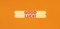 Good luck symbol. Concept words Good luck on wooden stick. Beautiful orange table orange background. Business, motivational good