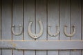 Good luck symbol. Set of old rusty horseshoes on a wooden background. Horseshoe is a symbol of good luck. Good luck concept Royalty Free Stock Photo