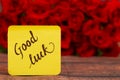 Good Luck text with Red roses in a bunch as a background. Royalty Free Stock Photo