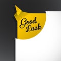 `Good Luck` text uncovered from torn paper corner.