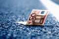 Good luck to find money as a symbol of profit. Close up Euro banknotes on the road. Money, wealth, business, success concept Royalty Free Stock Photo