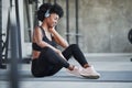 Good mood. African american woman with curly hair and in sportive clothes have fitness day in the gym Royalty Free Stock Photo