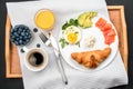 Good morning and Breakfast in bed on a wooden tray. Croissants, salmon and coffee in a European lunch