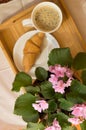 Good morning - Breakfast with coffee and croissant on a wooden tray and flowers violet pink Royalty Free Stock Photo