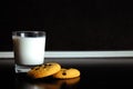 Good morning. Breakfast Cookies and a glass of milk. yogurt. Black background. Minimal black and white Royalty Free Stock Photo