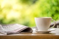 good morning coffee cup with news paper on nature green background in garden Royalty Free Stock Photo