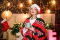 Good morning coffee. xmas mood. Woman drink cocoa. winter holidays. morning coffee. girl santa hat milk cup. Cheerful Royalty Free Stock Photo