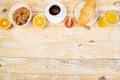 Good morning.Continental breakfast on ristic wooden background. Cup of coffee, orange juice, croissants, granola muesli on wooden Royalty Free Stock Photo