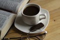 A Cup of coffee on a warm background. The open Bible. Glasses. Royalty Free Stock Photo