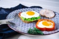 Sandwich with egg, ham, cheese, toast and salad leaves lies on a plate with tomato and dill Royalty Free Stock Photo