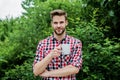 Good morning. fresh inspiration and energetic beverage. handsome bearded guy drinking tea outdoor. he loves cocoa. food