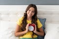 Good morning. Happy kid hold alarm clock in bed. Morning time. Wakening after sleep. Early riser Royalty Free Stock Photo