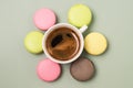 Good Morning or Have a Nice Day Message Concept White Cup of Espresso Coffee with Colourful French Macaroons on Green Background Royalty Free Stock Photo