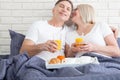 Good morning. Healthy breakfast in bed. Beautiful love couple is sitting in bed before having breakfast. Royalty Free Stock Photo