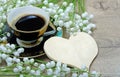 Good morning. morning coffee and lily of the valley flower on a wooden table.