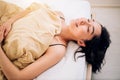 Portrait pretty young girl on bed in modern apartment in the morning Royalty Free Stock Photo